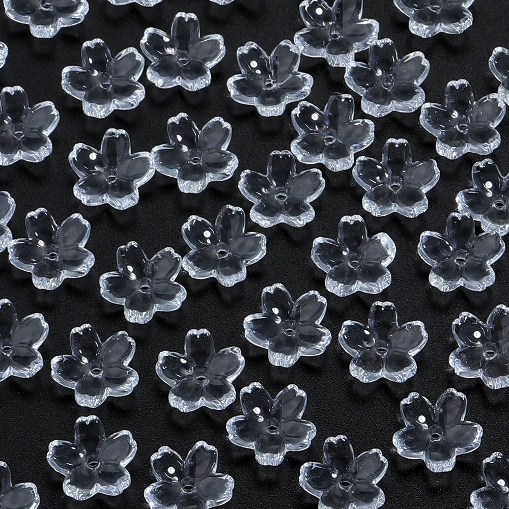 A close-up view of a 50-piece set of clear glass cherry blossom flower beads for jewelry making