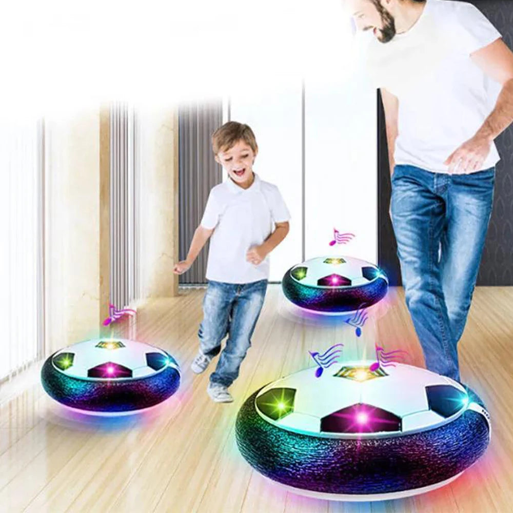 A floating soccer ball with LED lights is shown in a brightly lit room, with a boy standing nearby.