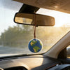 A handcrafted crochet earth keychain charm is suspended from a rearview mirror inside a car.