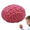A pink, brain-shaped stress relief ball is being held by a man.