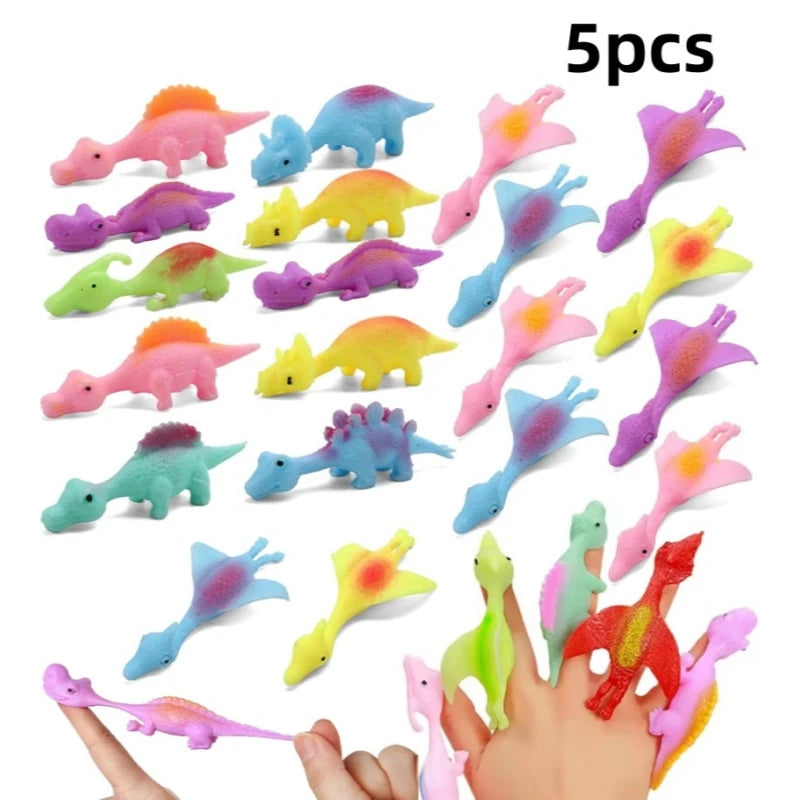 A set of five colorful rubber dinosaur slingshot toys held in a hand.