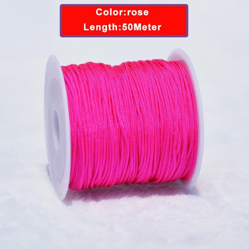 A spool of pink nylon knotting cord for jewelry making, 50 meters long.