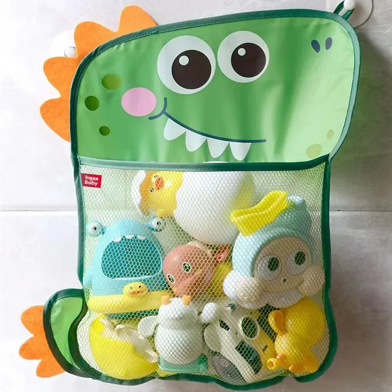 A green storage bag with a frog design holds various duck and frog toys.