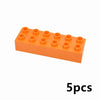 Un bloc rectangulaire de construction orange avec plusieurs protubérances circulaires, montrant cinq pièces.