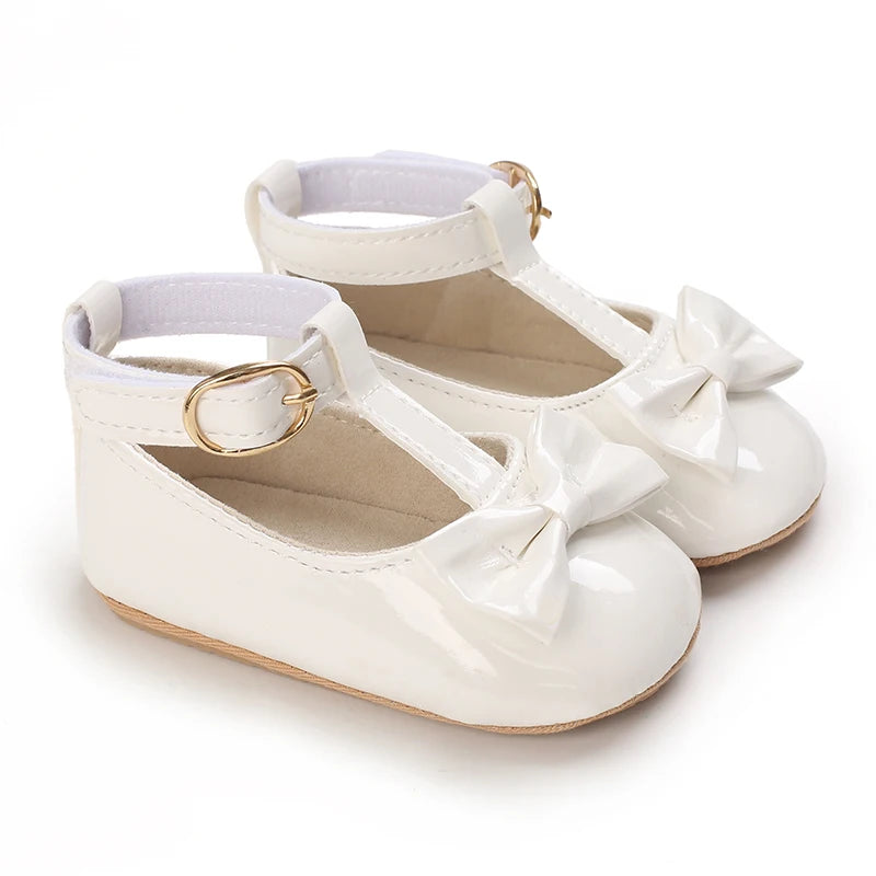 White baby first walker sandals with soft anti-slip soles and bow details