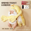 A yellow unicorn plush baby soothing pillow with a white hood and hands, shown against a light background.