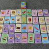 A grid of colorful flash cards featuring various food items and drinks for early learning.