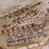 A collection of fabric-textured sticker strips in various colors and patterns for journaling and scrapbooking