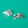 A collection of silver and gold building blocks resembling treasure chest coins on a teal surface.