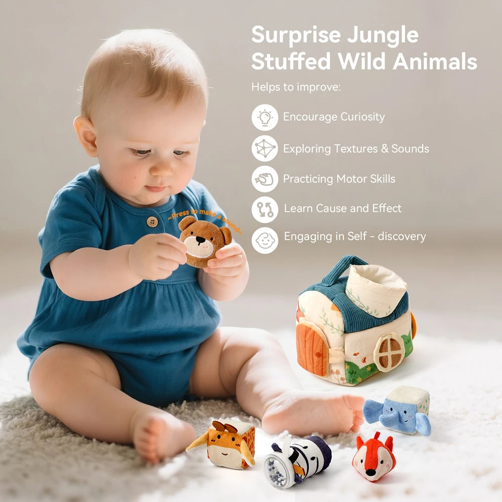 A baby is interacting with a stuffed wild animal toy, surrounded by other sensory toys like a tissue box and small animals.