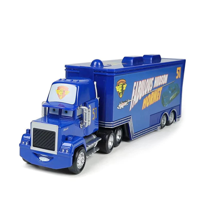 A blue diecast toy hauler truck modeled after a Hudson Hornet, featuring a yellow and orange logo.