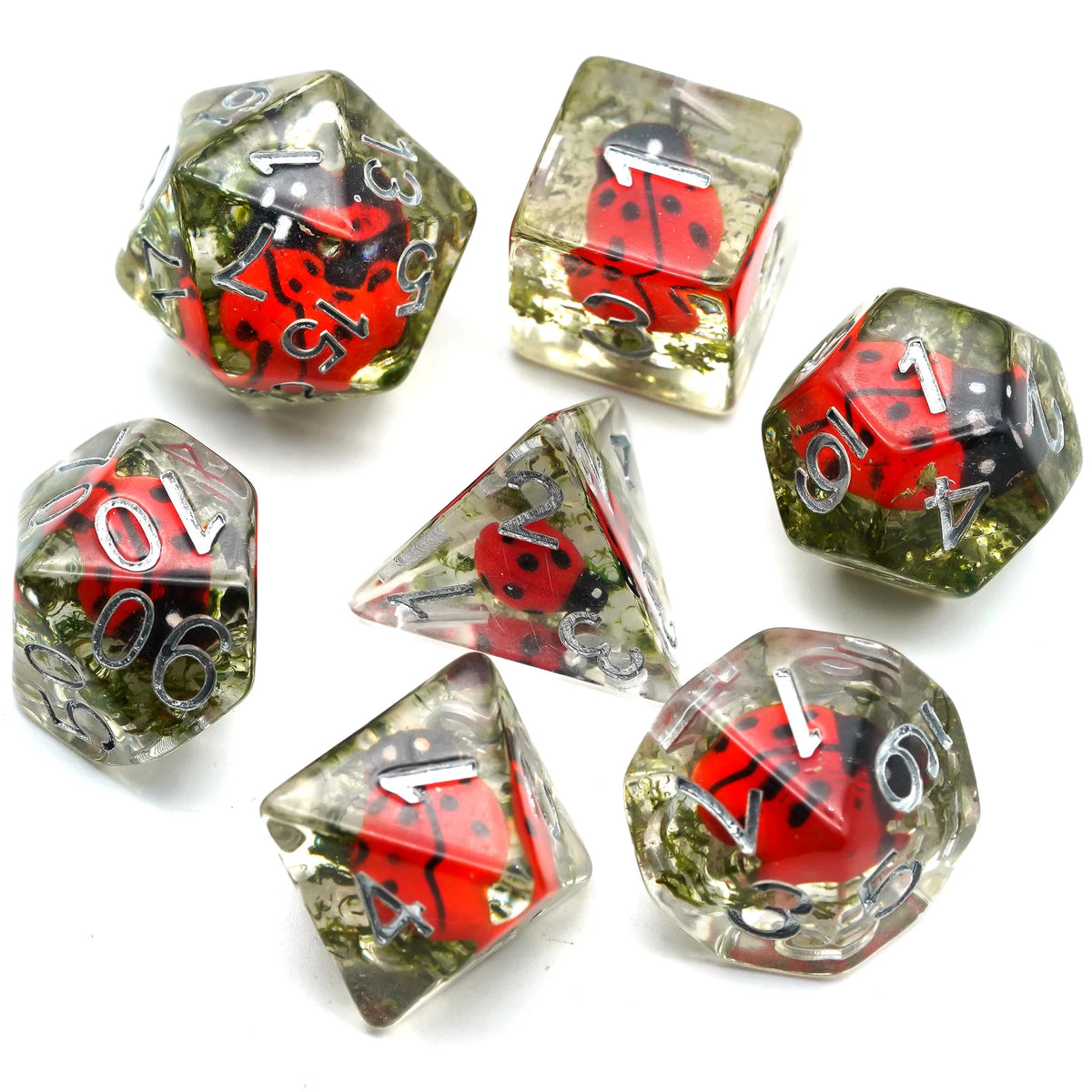 A set of polyhedral dice featuring red ladybug designs and green accents for tabletop role-playing games