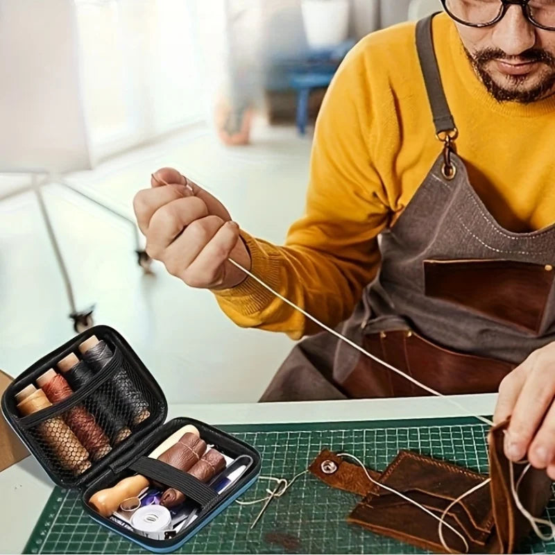 A person is using a leather sewing kit with waxed thread and needles on a green cutting mat.