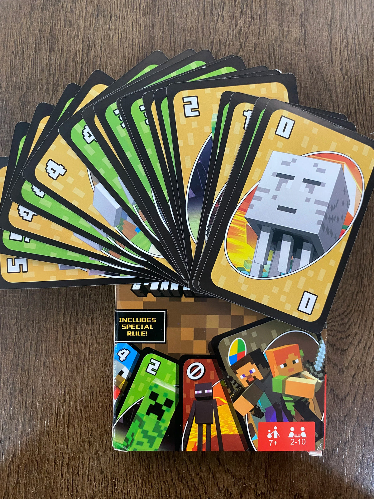 A stack of FLIP! matching cards featuring pixel art characters and numbers, including a special rule card.