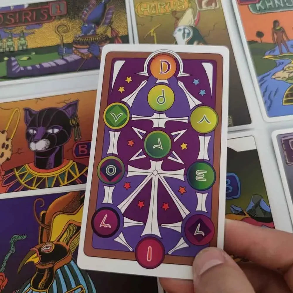 A hand holds a JoJo-inspired tarot card from a deck featuring colored symbols and imagery.