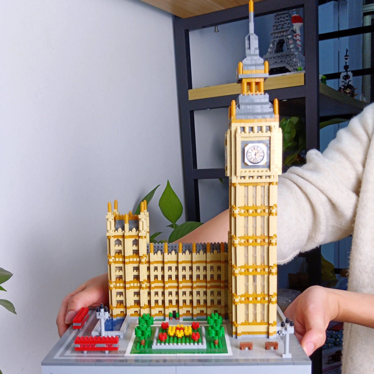 A model of the Eiffel Tower built from LED-illuminated micro building blocks on a gray base.