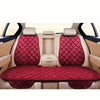 Interior view of a car seat with three plush anti-slip cushions in maroon and beige.