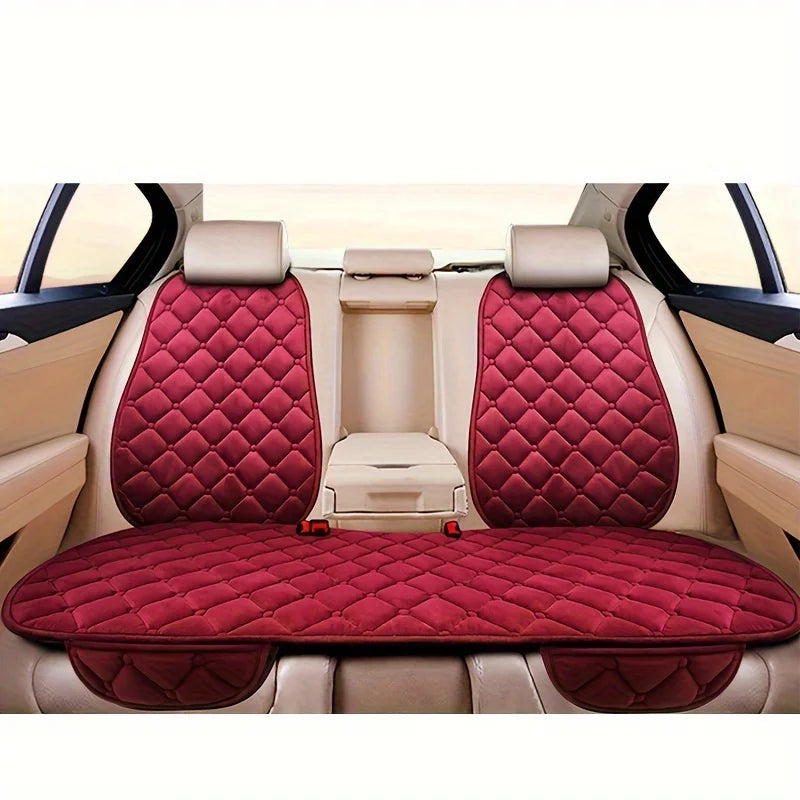 Interior view of a car seat with three plush anti-slip cushions in maroon and beige.