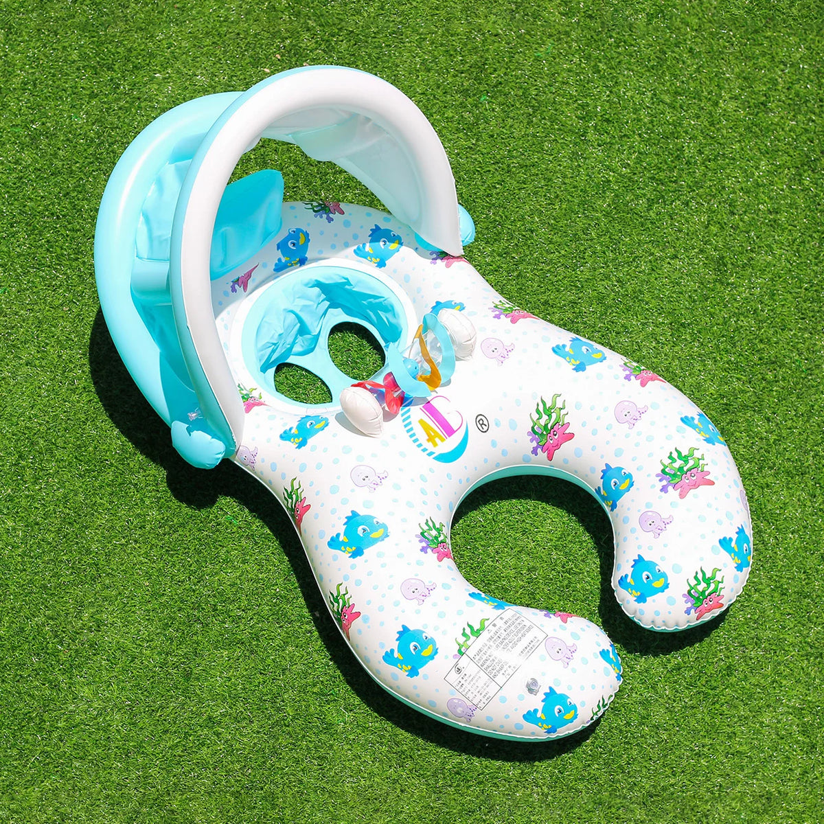 A light blue inflatable pool lounger for two with a sun canopy and backrest resting on green grass.