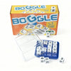A box of Boggle dice game with a clear plastic container and several white wooden dice scattered on a white surface.