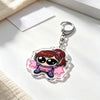 A clear acrylic keychain charm featuring an anime-inspired character with pink hair and headphones.
