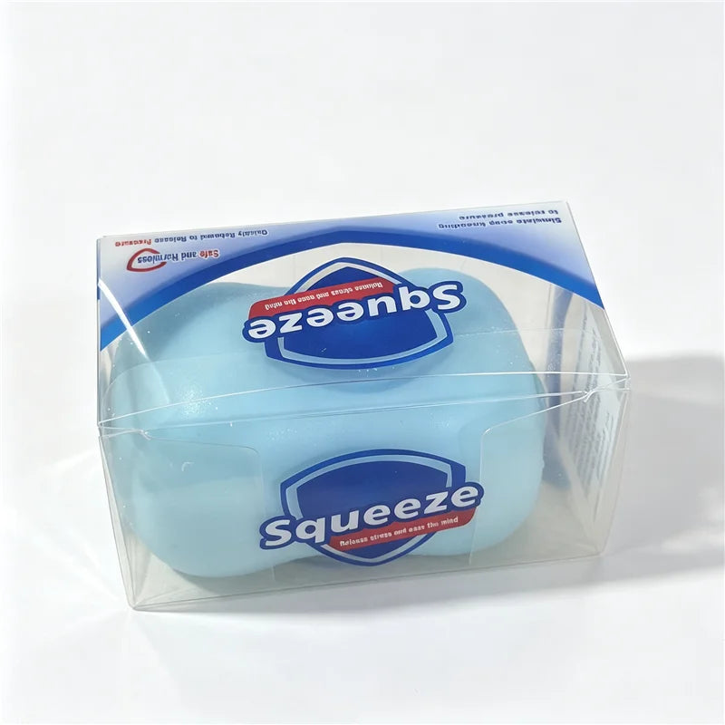 A clear plastic container holding a light blue squishy fidget block with a blue label.