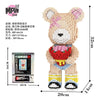A fully assembled bear figure made of wooden building blocks, featuring pink and white coloring.