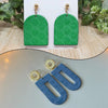 Two green oval earrings with a floral texture design displayed on a white background.