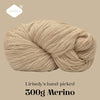 A ball of light beige Merino wool yarn, hand-picked and 300g, shown in a coiled shape.