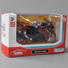 A diecast model of a black and red Suzuki GSX-R1000R motorcycle is displayed in its packaging box.