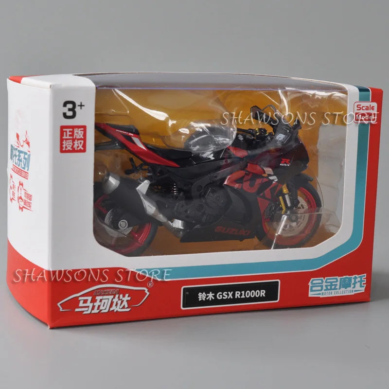 A diecast model of a black and red Suzuki GSX-R1000R motorcycle is displayed in its packaging box.