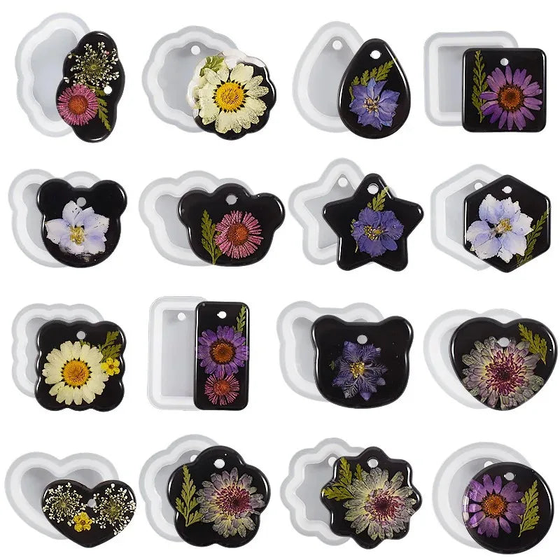 A collection of heart-shaped silicone molds for resin jewelry making featuring various floral designs in black and purple.
