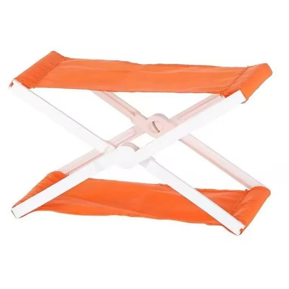 Orange foldable camp pillow with white frame and straps.