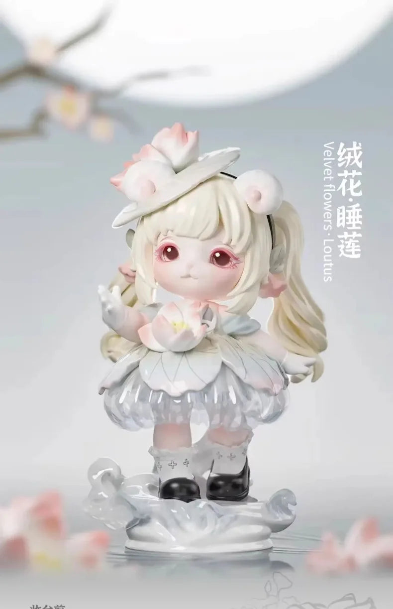 A white collectible figurine of a girl with light blonde hair and pink accents, featuring velvet flowers and a delicate dress