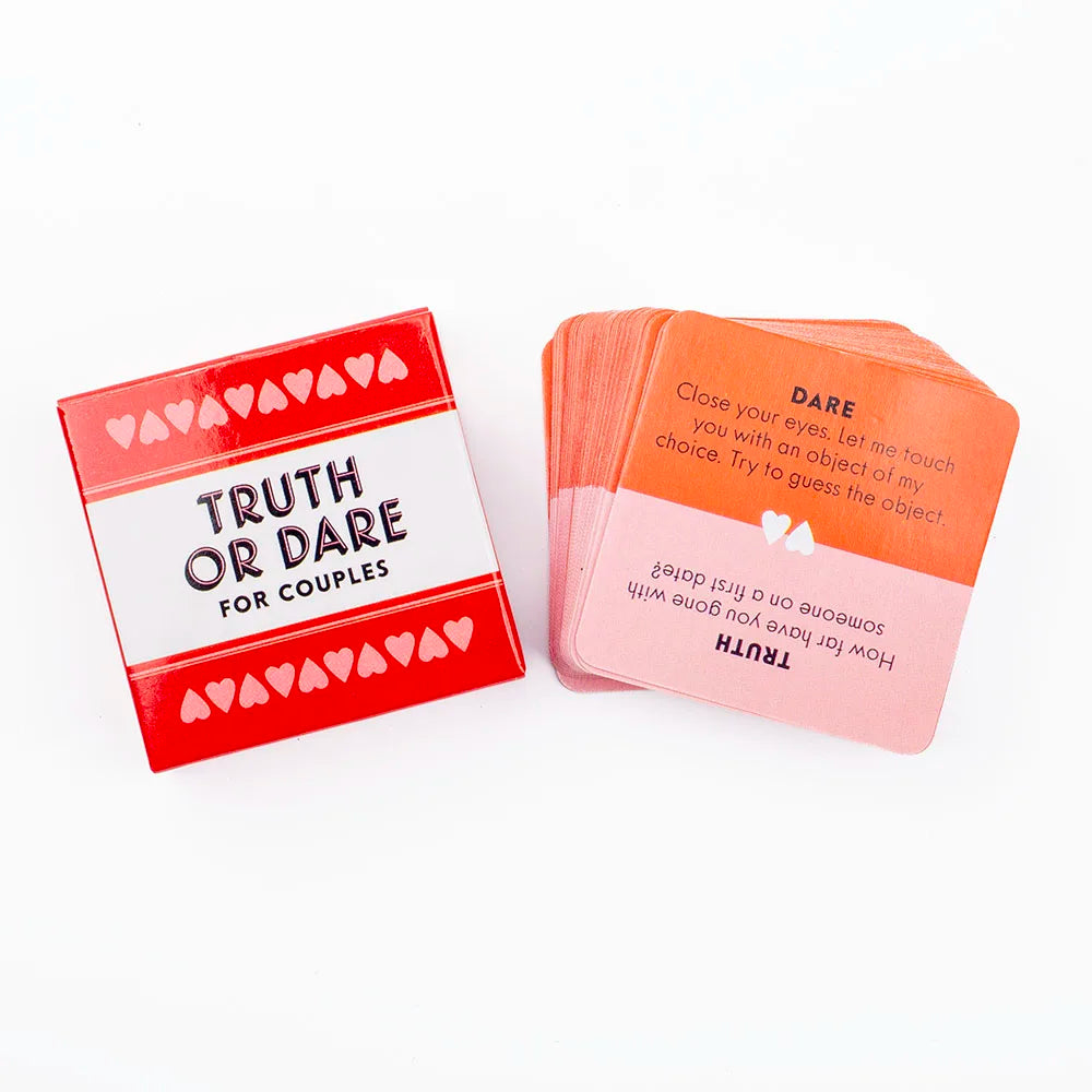 A deck of red and pink cards for a truth or dare game for couples featuring prompts like Dare and Truth.