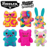 A collection of colorful Fuggler plush monster toys featuring various facial expressions and textures.