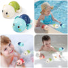 A set of cartoon monkey shower toys including a large blue and green toy, small orange and yellow toys, and a pink toy used f