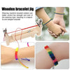 A wooden bracelet weaving jig and finished colorful woven bracelets on a hand.