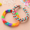 A colorful glow-in-the-dark loom band bracelet making kit with braided threads on a light background.