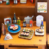 A wooden miniature dollhouse kit featuring various food items and a bottle in a restaurant setting.