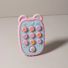 A pink phone-shaped silicone teether for babies with various buttons and features.