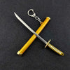 A samurai sword keychain with a yellow hilt and silver blade, featuring a decorative grip.