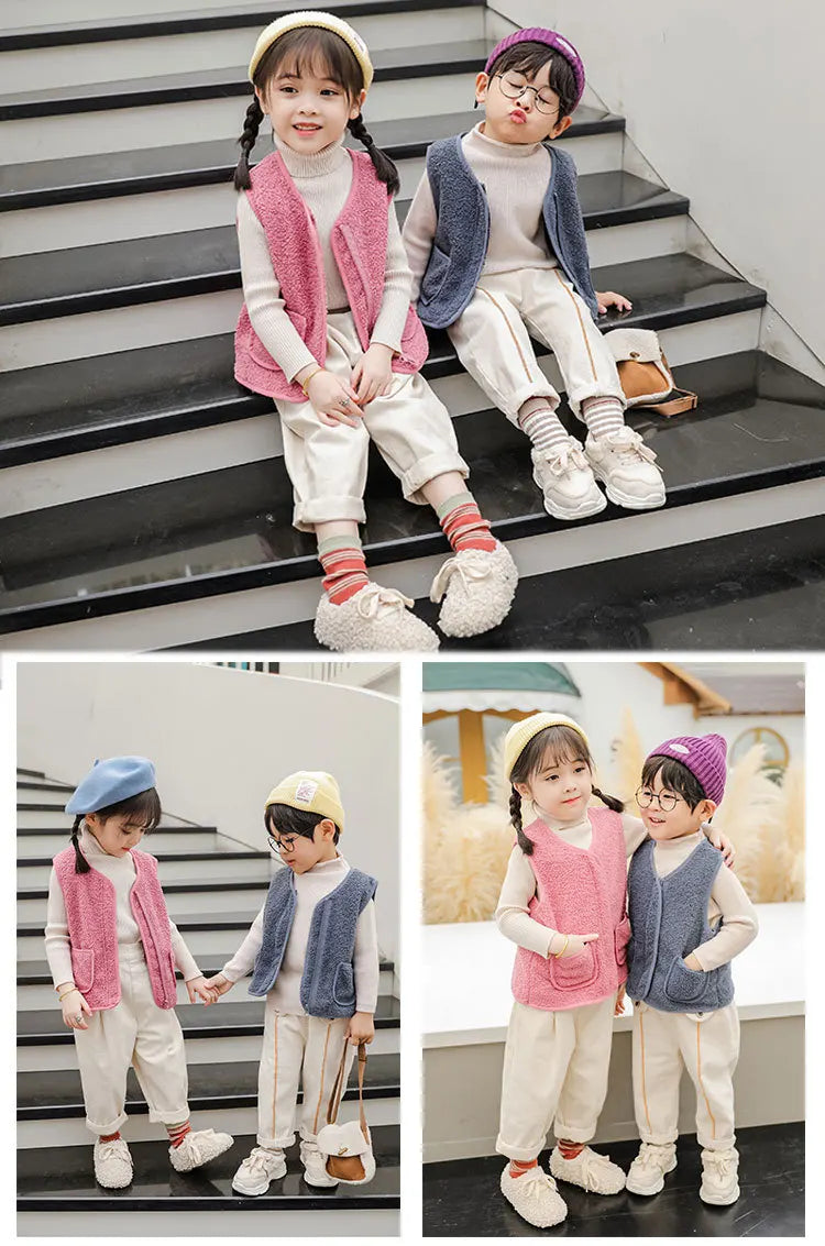 Two children wearing cozy lamb wool baby vests and light-colored pants sitting on stairs.