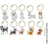 A collection of dog-shaped pet hair keepsake keychains featuring various breeds and sizes.