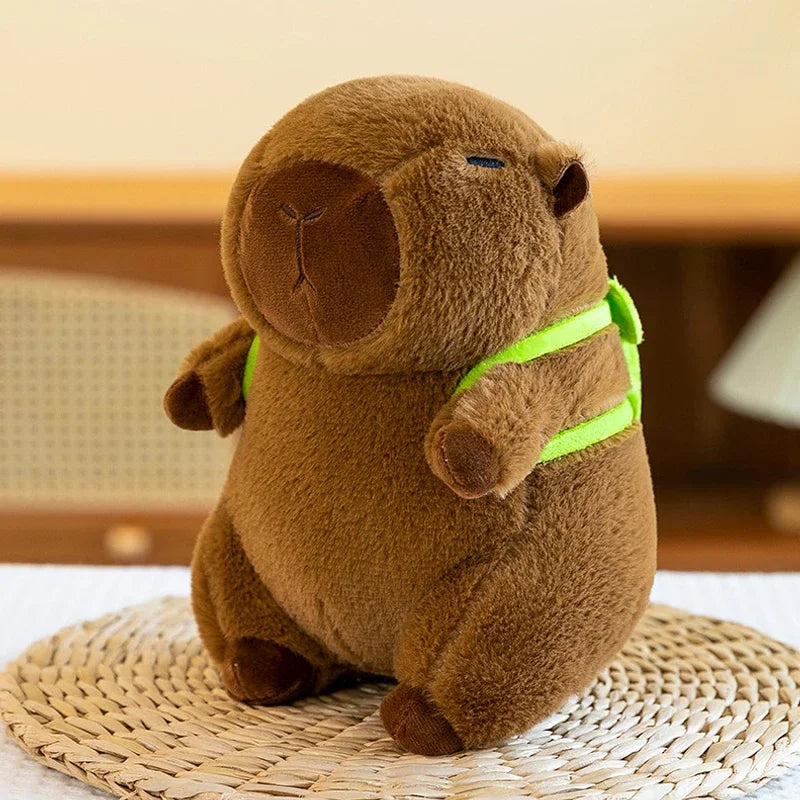 A brown capybara plush toy with bright lime green accents sitting on a woven mat.