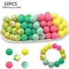 A collection of 50 silicone floral beads in various colors including green, yellow, pink, and lime shades.