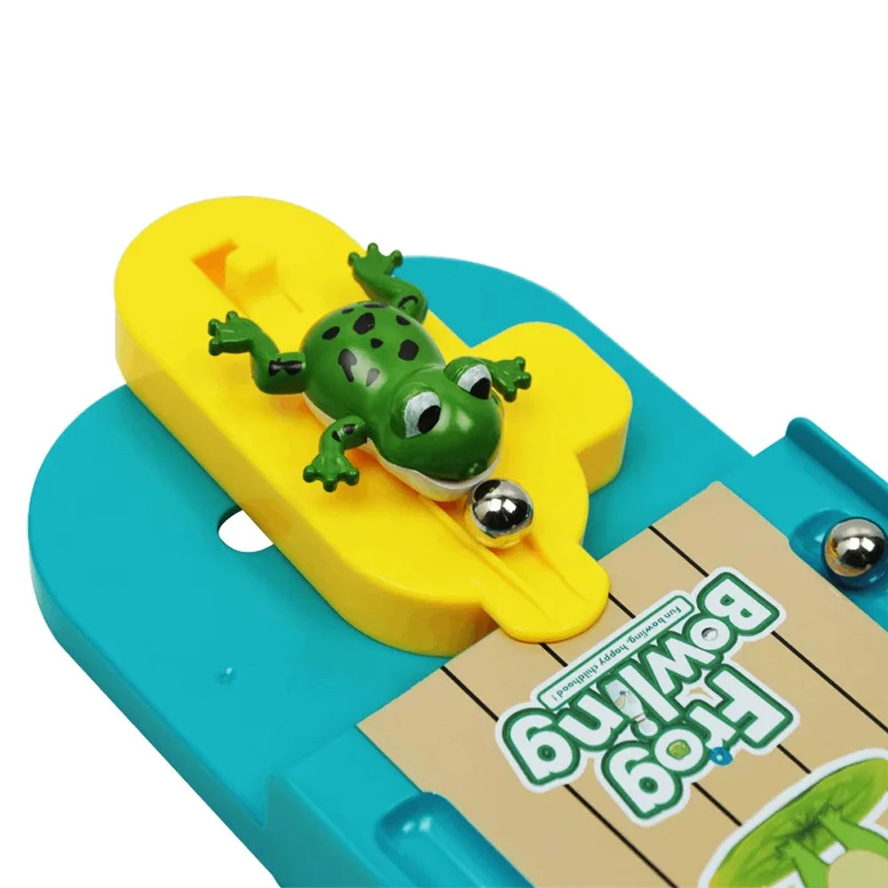 A mini frog bowling game set featuring a green frog on a yellow bowling pin placed on a blue base.