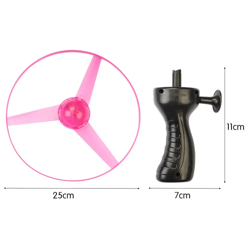 A black spinning top toy with a pink LED flying disc, showing its size and components.