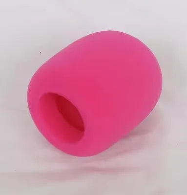 A pink foam windscreen pop filter cover with a circular opening.