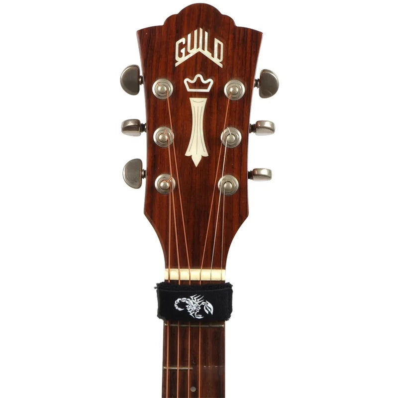 A close-up view of a guitar tuner featuring a wooden neck and metal tuning pegs.